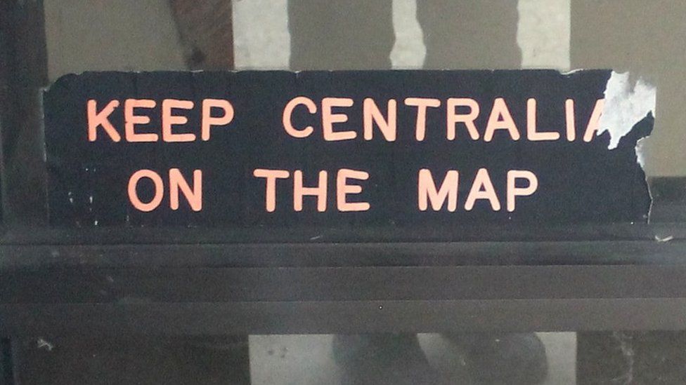 Keep Centralia on the Map: A sticker on the door of Centralia's municipal building, one of its few remaining structures
