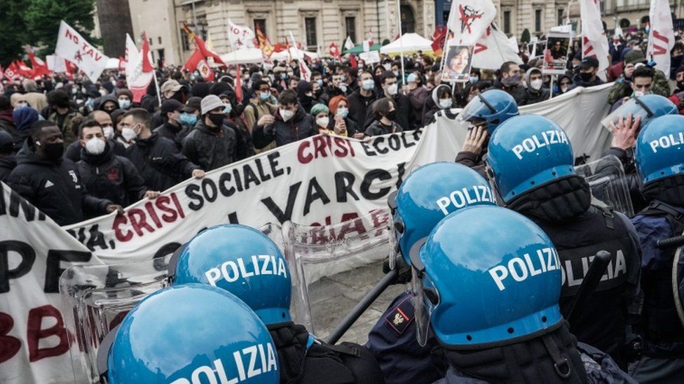 Лейбористские активисты сталкиваются с полицией, когда они принимают участие в акции протеста в Первомай или Международный день трудящихся в Турине, Италия