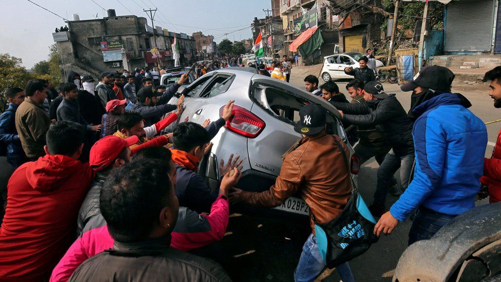 Demonstrators overturn a car during a protest against the attack on a bus that killed 44 Central Reserve Police Force (CRPF) personnel in south Kashmir on Thursday, in Jammu February 15, 2019.