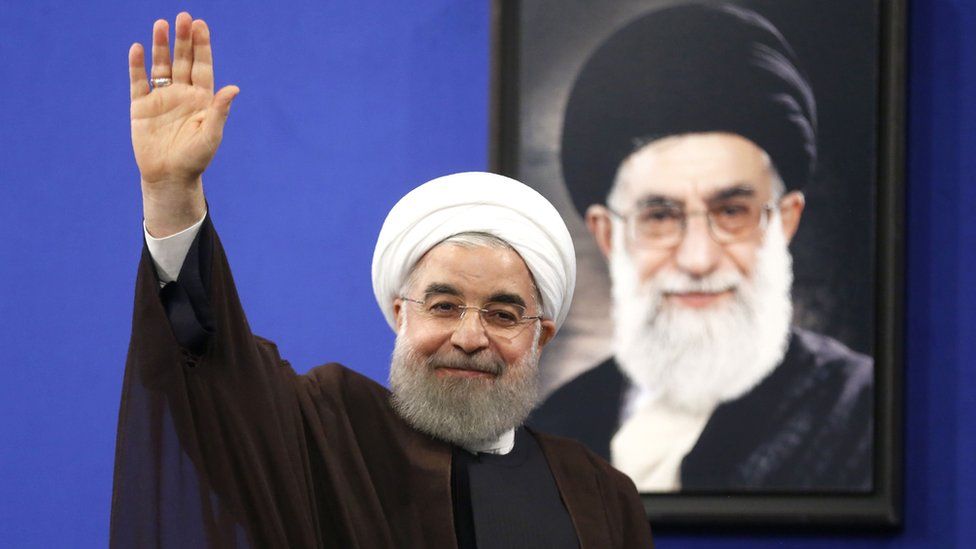 Newly re-elected Iranian President Hassan Rouhani gestures after delivering a televised speech in the capital Tehran