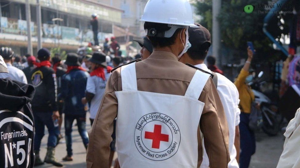 A member of Red Cross walks amid protests against the military coup in Dawei