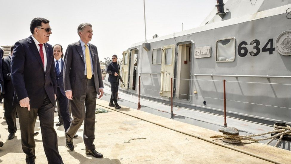 Foreign Secretary Philip Hammond, right, tours a naval base with Libya's prime minister-designate Fayez Sarraj during his visit to Tripoli, Libya