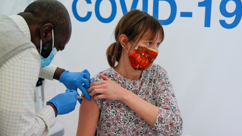 A woman receives a dose of a Covid-19 vaccine in a vaccination centre