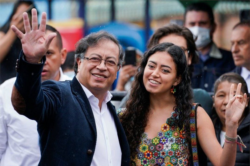 Colombian left-wing presidential candidate Gustavo Petro of the Historic Pact coalition waves as he stands with a family member during the first round of the presidential election in Bogota, Colombia May 29,