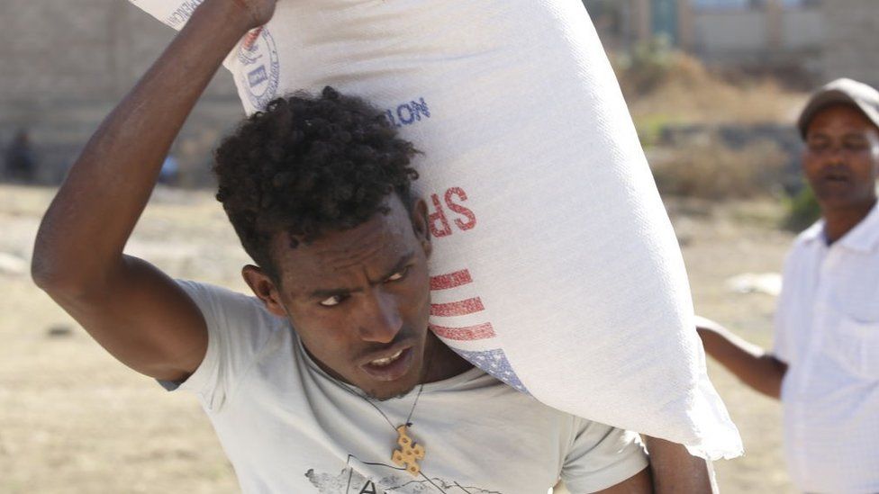 Tigray people, fled due to conflicts and taking shelter in Mekelle city of the Tigray region, in northern Ethiopia, receive the food aid distributed by United States Agency for International Development (USAID) on March 8, 202