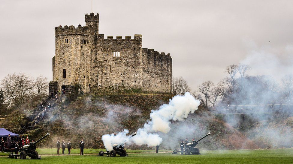 Members of C Troop 211 Battery fire a 21-gun salute in the grounds of Cardiff Castle