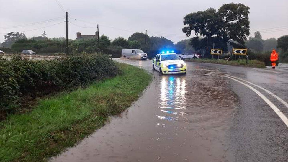 Flooded road with police vehicle