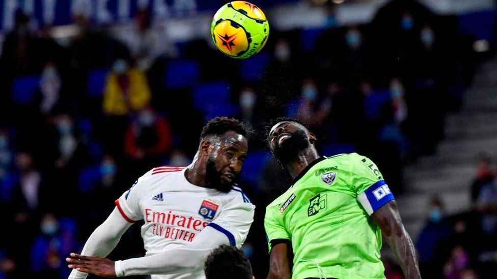 Lyon's French forward Moussa Dembele (L) and Dijon's Gabonese defender Bruno Ecuele Manga (R) jump to head the ball during the French L1 footall match between Olympique Lyonnais (OL) and Dijon FC on August 28, 2020, at the Groupama Stadium in Decines-Charpieu, near Lyon, central-eastern France.