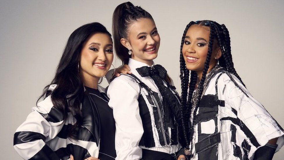 Yazmin, Maisie and Hayla stand in a line wearing black and white outfits