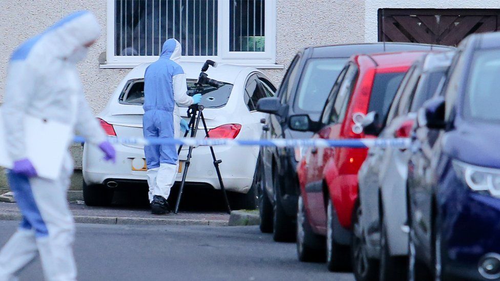 Police forensic officers at the scene of the shooting