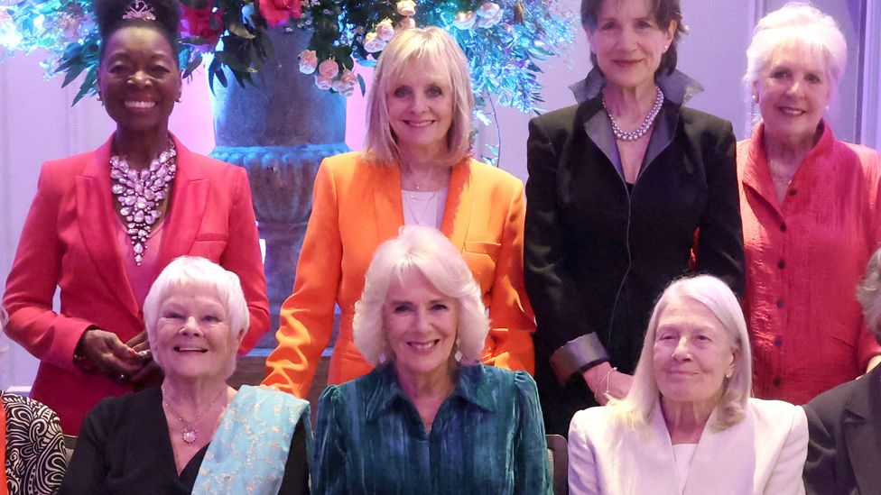 Queen Camilla smiles as she poses with Dames Floella Benjamin, Twiggy Lawson, Harriet Walter, Penelope Wilton, Judi Dench and Vanessa Redgrave at the "Celebration Of Shakespeare" at Grosvenor House in London