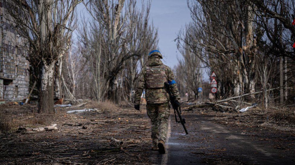 A soldier walks through Bakhmut