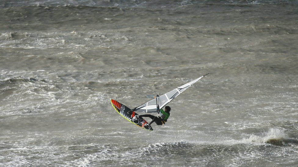 A windsurfer in the sea of Newhaven in East Sussex where storm Katie brought high winds and choppy waters