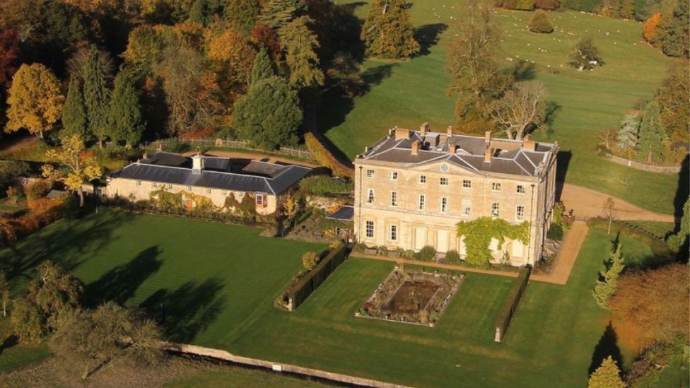 Three-storey Northamptonshire stone stately home with formal garden in front and parkland behind