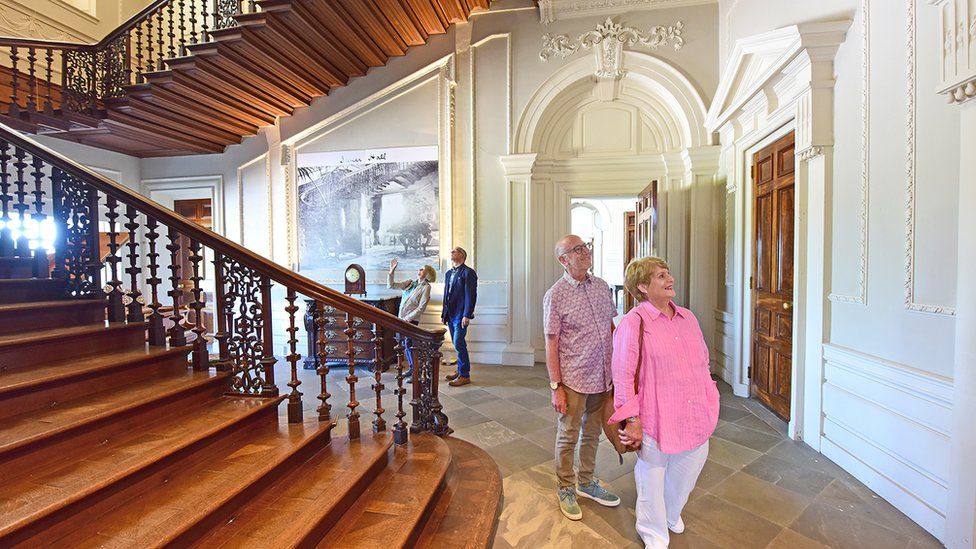 Visitors standing in front of a large staircase