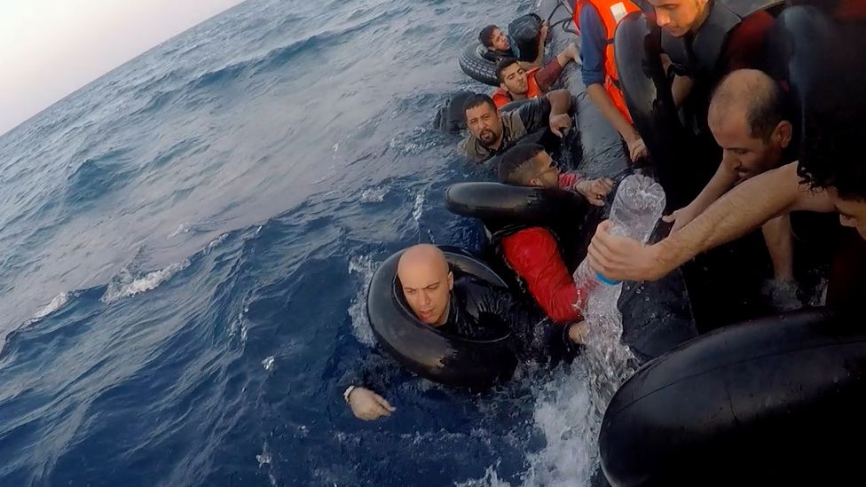 Migrants on a sinking dinghy