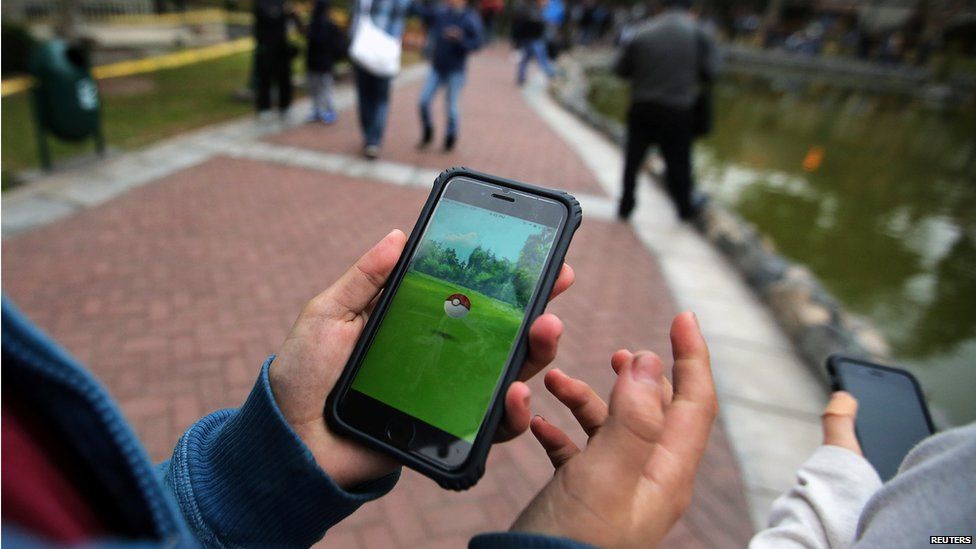 People playing Pokemon Go in a park