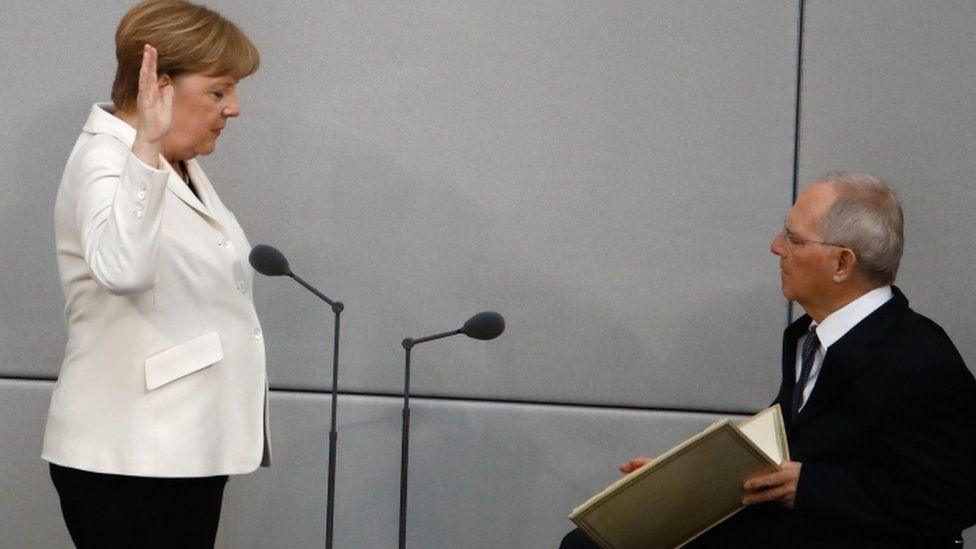 Angela Merkel takes the oath with Bundestag president Wolfgang Schaeuble