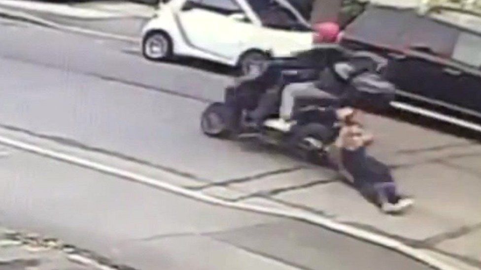 Woman dragged by moped