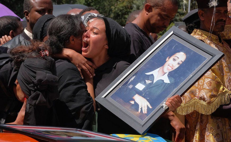 A woman cries over the coffin of her loved one during a memorial service for the Ethiopian passengers and crew who perished in the Ethiopian Airways ET302 crash - March 2019