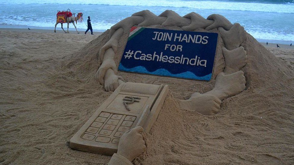 A sand sculpture by sand artist Sudarshan Pattnaik about Cashless India campaign