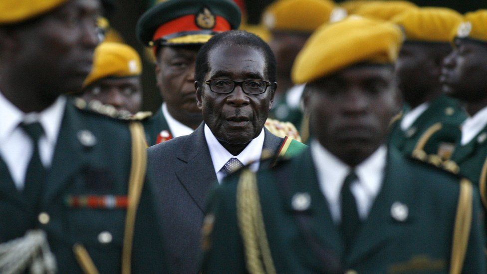 Zimbabwean President Robert Mugabe (C) with soldiers in 2008