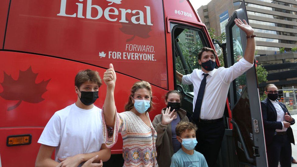 Justin Trudeau, his wife Sophie Gregoire Trudeau and their children Xavier, Ella-Grace and Hadrien wave to supporters while boarding his campaign bus