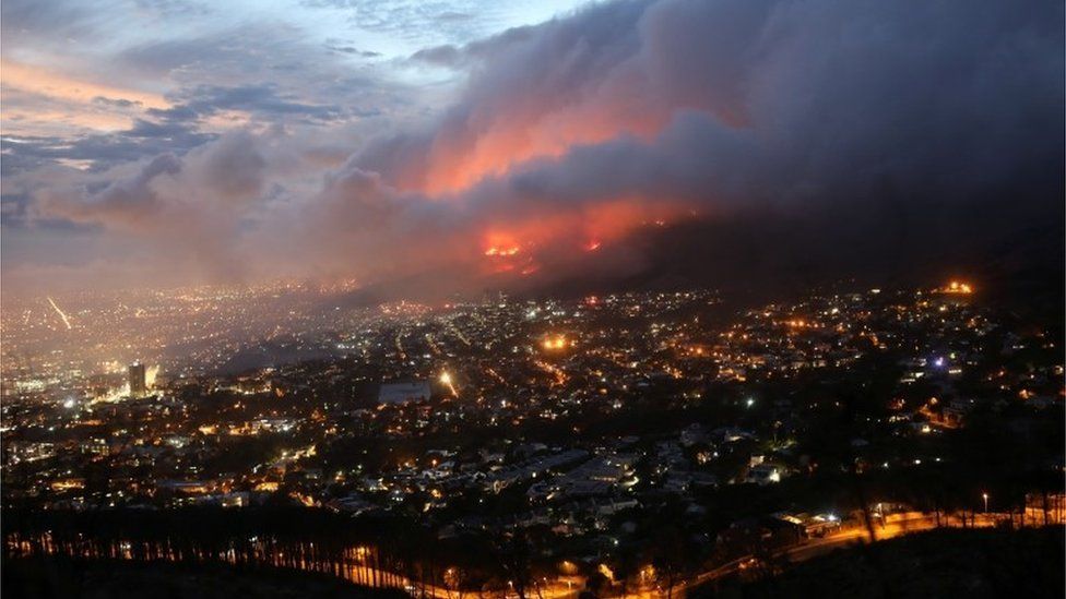 Flames are seen close to the city fanned by strong winds after a bushfire broke out on the slopes of Table Mountain in Cape Town, South Africa, April 19, 2021