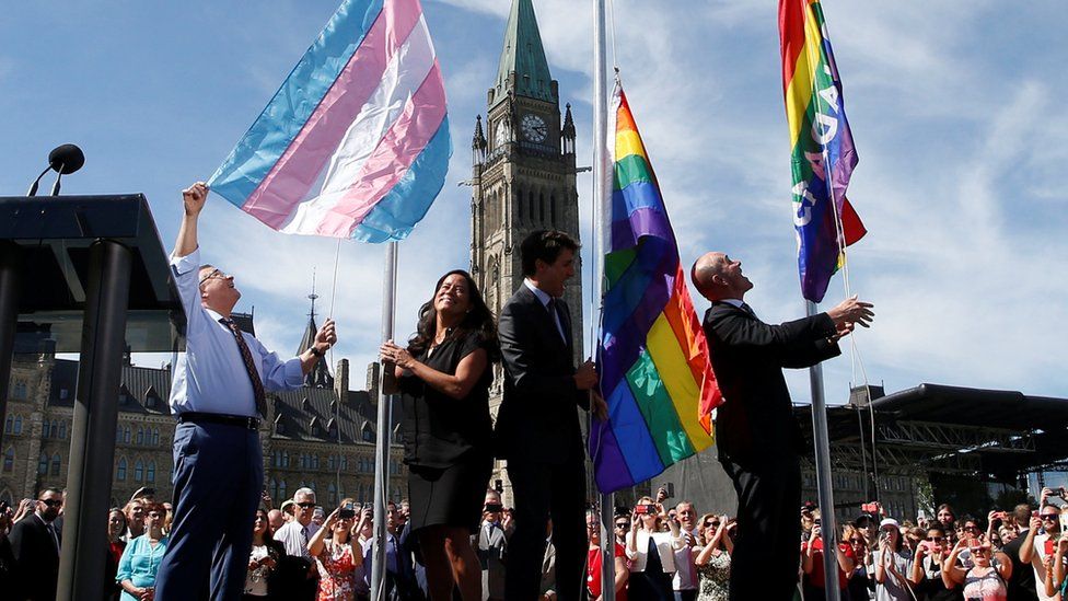 Canada's Public Safety Minister Goodale, Justice Minister Wilson-Raybould, PM Trudeau and Liberal MP Boissonnault raise pride flags on Parliament Hill in Ottawa
