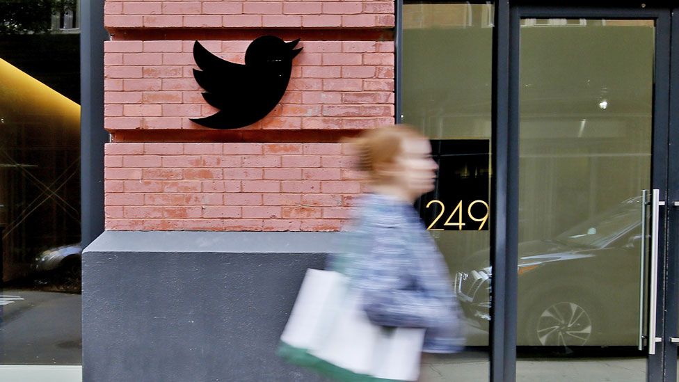 A woman walks past the Twitter Headquarters on 28 October 2022 in New York City, US
