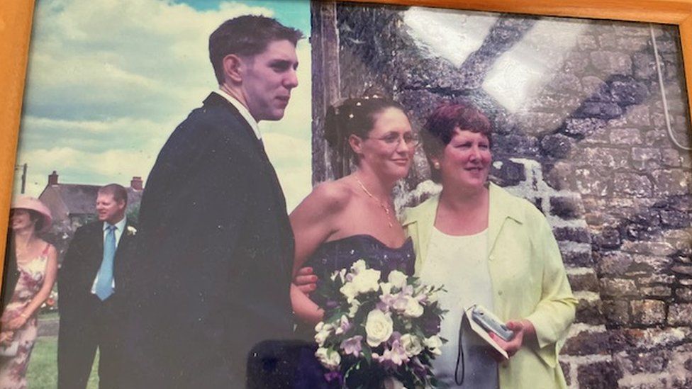 An old photo of James with his sister and mother