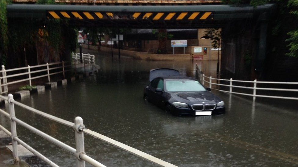 A marooned vehicle in middle of a flash flooding in south London