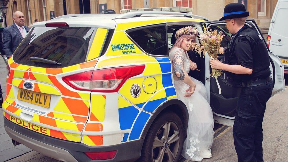 Yasmin Lovekin stepping out of police car in wedding dress