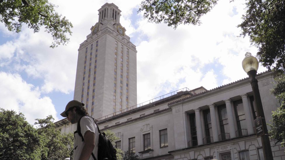 A student walks at the University of Texas campus in Austin