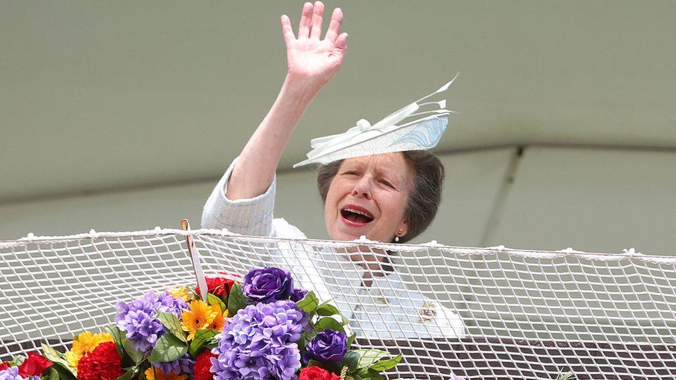 Princess Anne waving to crowds from the royal box at Epsom