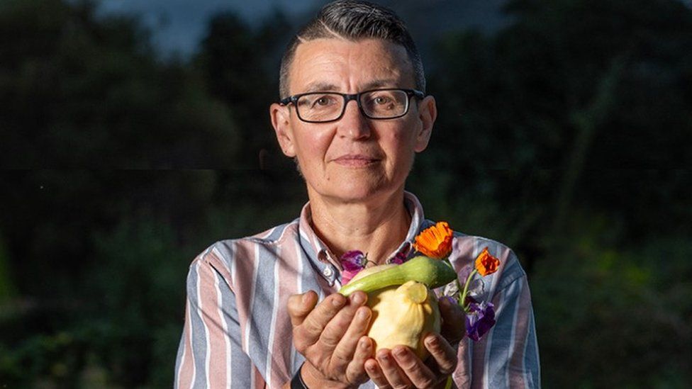 One of the photographer's subjects holding vegetables