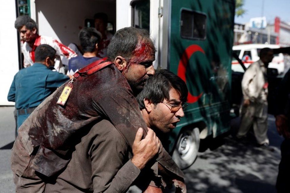 A man carries one of the injured in the blast. Photo: 31 May 2017