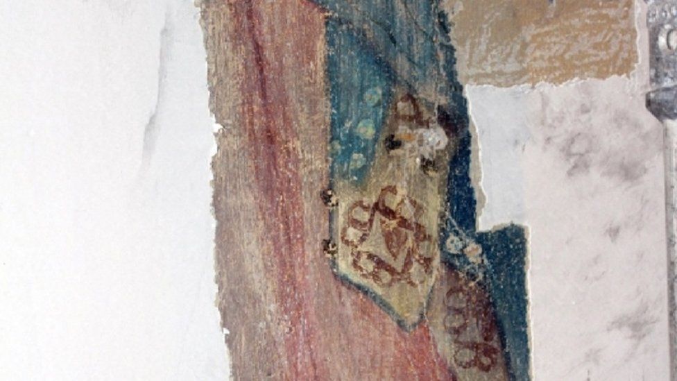 Robes of a figure on the upper north wall