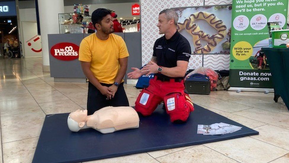 Paramedic talks to a member of the public