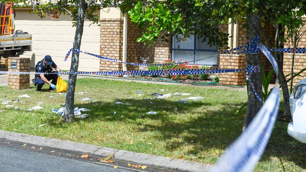 Officer bagging evidence in front garden of house in North Lakes, Brisbane