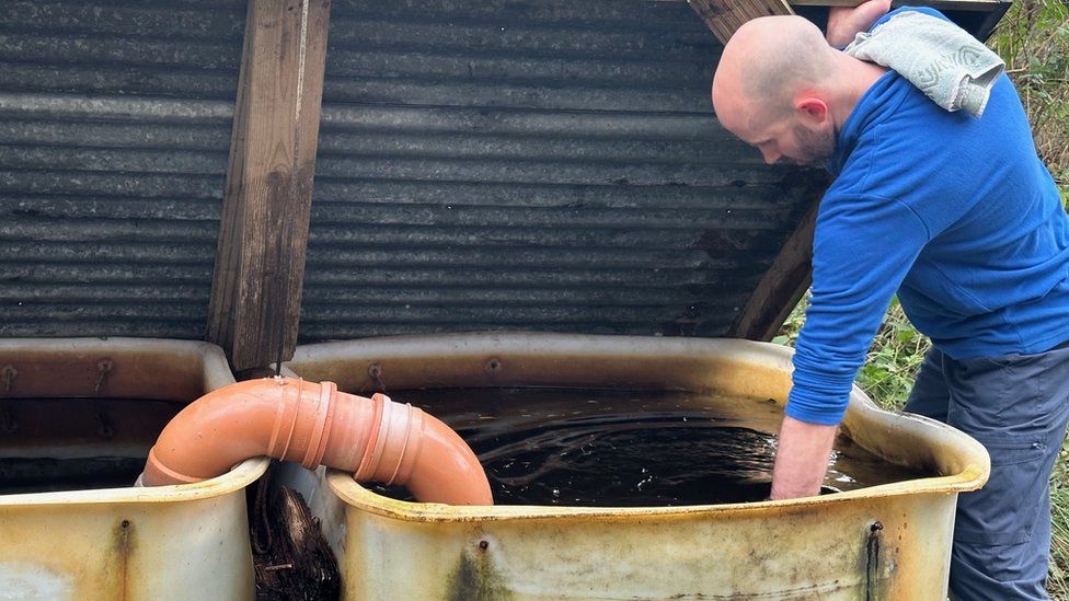 Chris Johnson with the water tank