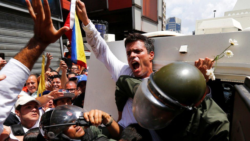 Venezuelan opposition figure Leopoldo López gets into a National Guard armoured vehicle in Caracas, 18 February 2014