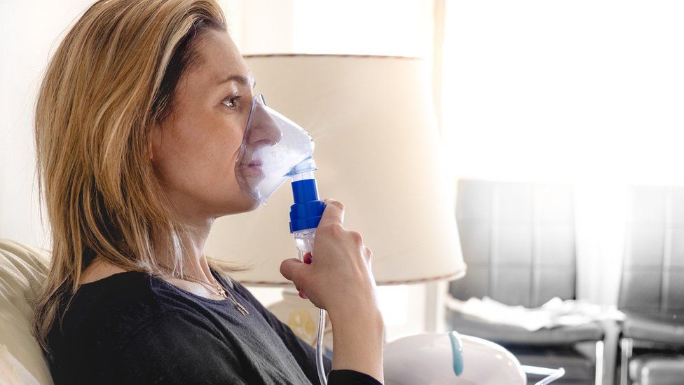 woman using nebuliser