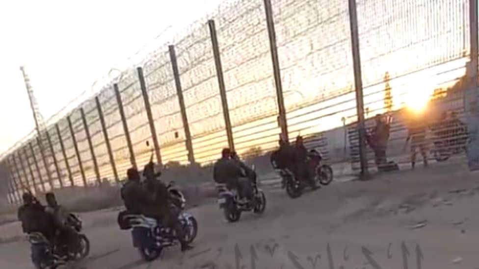 A line of militants on motorbikes