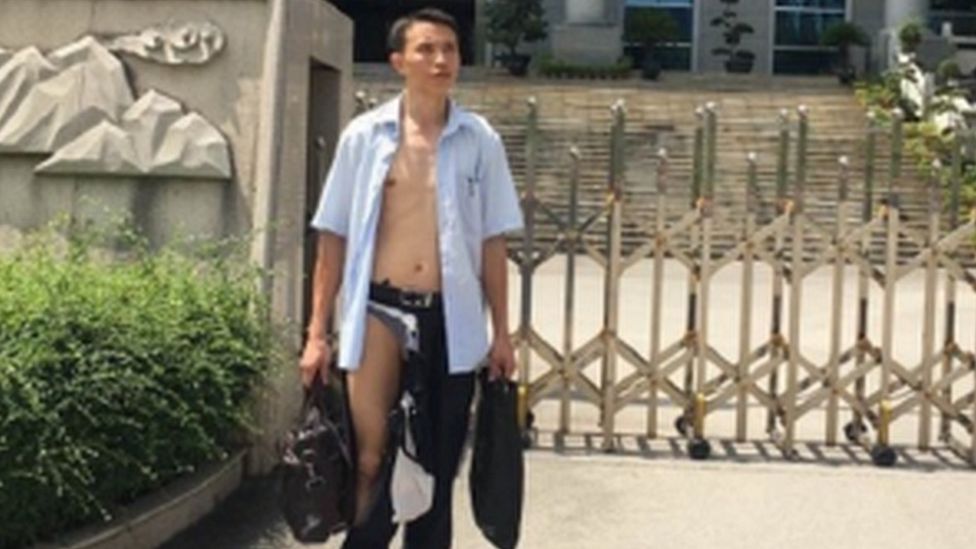 A photo showing Wu Liangshu in a ripped shirt and trousers