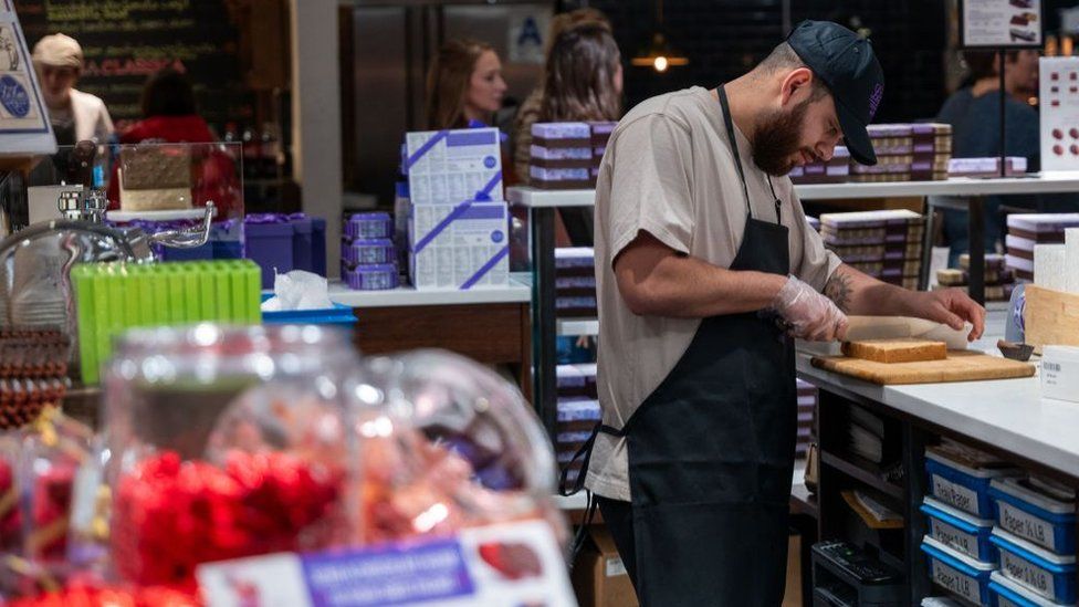 A man makes deserts at a store at Chelsea Market in Manhattan on February 02, 2024 in New York City.