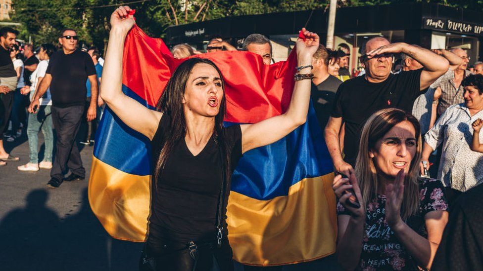 A supporter of Nikol Pashinyan main candidate of the Civil Contract party for the parliamentary elections is seen with the Armenian flag