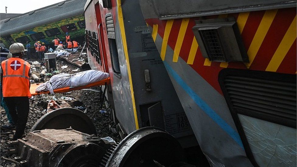 The body of a victim is carried out of the wreckage at the accident site of a three-train collision near Balasore, about 200 km (125 miles) from the state capital Bhubaneswar in the eastern state of Odisha, on June 3, 2023. At least 288 people were killed and more than 850 injured in a horrific three-train collision in India,