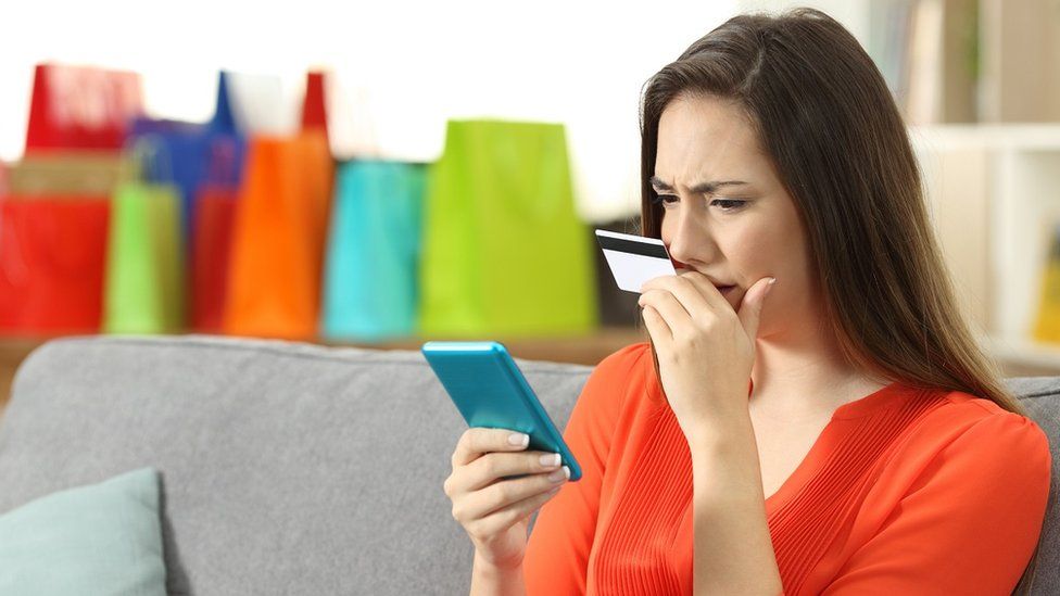 Woman looking at credit card
