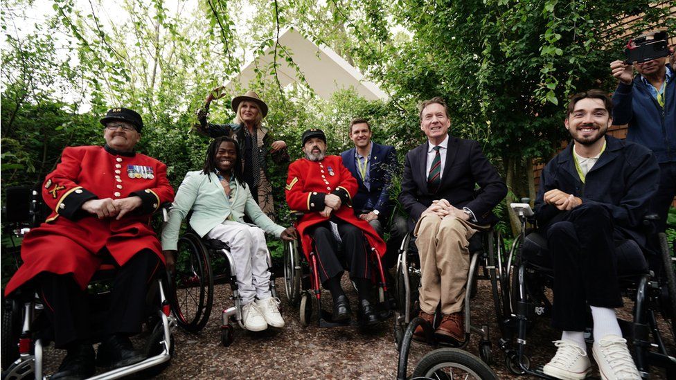 TV presenter Ade Adepitan, Dame Joanna Lumley, BBC security correspondent Frank Gardner and actor George Robinson in Horatio's Garden with two Chelsea Pensioners